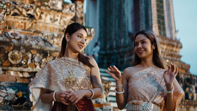 Thai women celebrating loi krathong day at wat arun temple in traditional dress