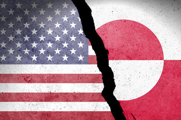 Flag of USA and Greenland painted on a concrete wall with soldier © Tomas Ragina