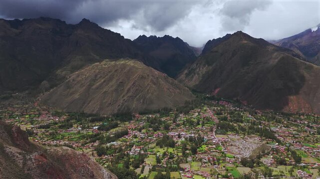 Chic&oacute;n town Peru Per&uacute; aerial drone rainy season cloudy Peruvian Andes canyon Mount Patacancha Cuncani Pumahuanca glacier Sacred Valley Quelccaya Urubamba range cusco region forward pan up motion
