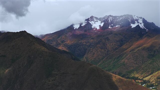 Peruvian Andes high altitude glacier Sacred Valley Chic&oacute;n Peru Per&uacute; aerial drone rainy season Maras Salt Mine cloudy morning Quelccaya Glacier Urubamba valley mountain range cusco region parallax left