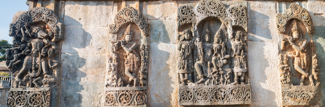 Detailed stone carving Halebeedu ancient temple Karnataka India showing warriors deities animals intricate sculptural art symbolizing heritage culture devotion