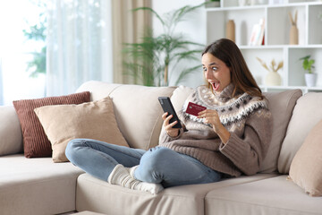Shocked woman in winter at home buying online
