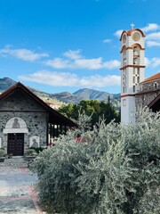 Church of Panagia Eleousa (&Pi;&alpha;&nu;&alpha;&gamma;ί&alpha; &Epsilon;&lambda;&epsilon;&omicron;ύ&sigma;&alpha;) in the mountain village of Agros, Cyprus, surrounded by lush hills, traditional stone architecture, and a peaceful village atmosphere