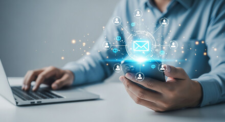 Man using smartphone and laptop with email marketing and newsletter concept for customer engagement strategy