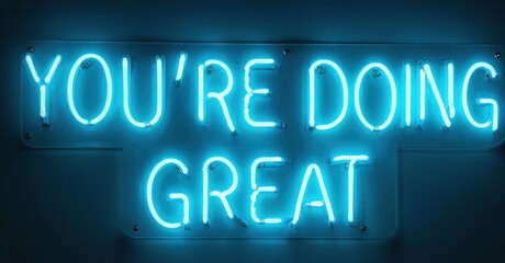 Bright neon sign displays positive message. Blue glow against dark background creates striking visual impact. Encouragement, motivation, support.