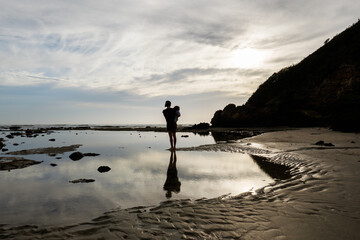 A woman and child watch the ocean