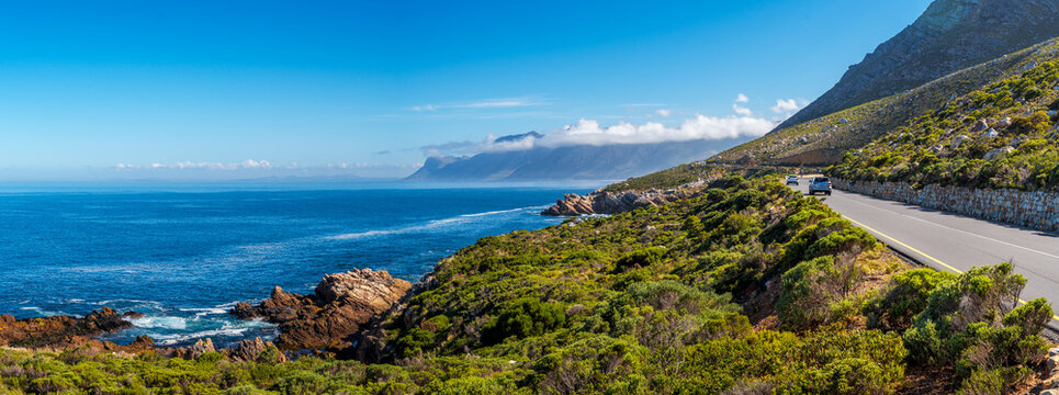 Holiday views of cloud-covered Hottentots Holland Mountains from Clarence Drive, between Gordon's Bay and Rooi-Els, Western Cape, South Africa. Perfect scenic drive for road trips and travel.