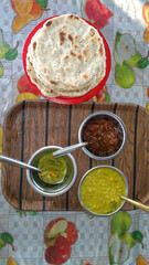 Traditional Indian Roti with Dal, Green Chutney and Pickle on Wooden Tray, Top View
