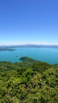 Smooth pan to the right showing Lake Ilopango in El Salvador vertically