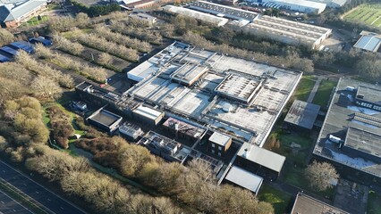 Aerial drone view of huge data Center, AI and Quantum cloud storage IT information systems and cooling units turbines. Sunny day in Royal Leamington Spa, United Kingdom 