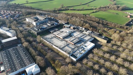 Aerial drone view of huge data Center, AI and Quantum cloud storage IT information systems and cooling units turbines. Sunny day in Royal Leamington Spa, United Kingdom 