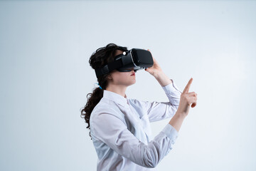 Woman adjusting virtual reality headset while working with immersive digital technology and futuristic virtual systems