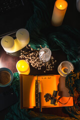 Cozy workspace with to-do list, coffee and candles &ndash; planning and mindfulness concept