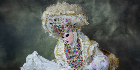 a costume a fantastic mask in front of a black background with smoke