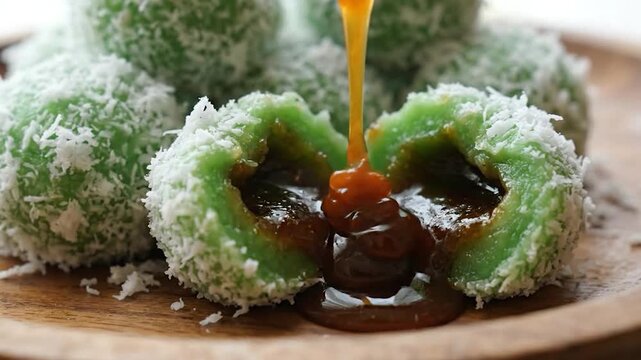 Delicious Klepon - Traditional Indonesian Green Rice Cake with Palm Sugar Filling and Coconut Shreds.