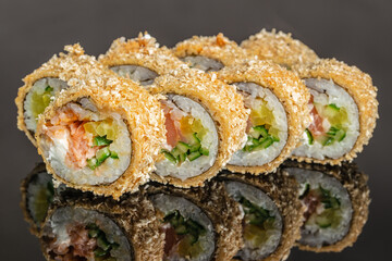 Baked sushi roll with salmon cucumber and crunchy coating close up © Надія Коваль