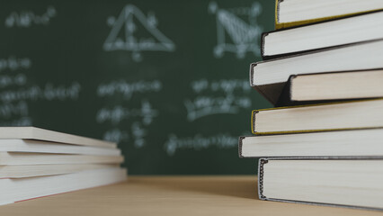 School Books on Desk with Math Formulas Blackboard Background. 3d rendering