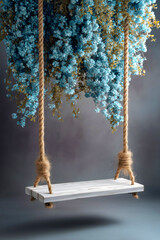 Ethereal wooden swing backdrop decorated with cascading blue flowers and rope for photography studio background.