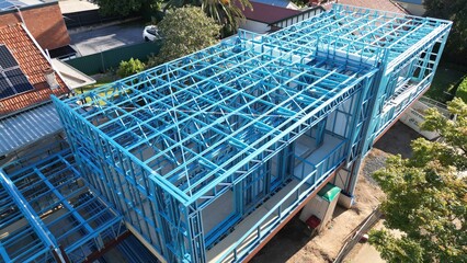 Steel frame house under construction, modern residential building site