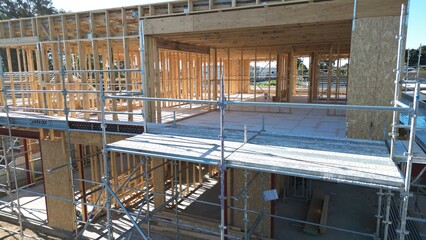 Wooden house frame under construction, timber structure residential building site
