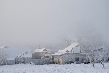 Fog covered the houses in the village in the morning