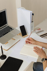 Woman making anotes at Home Office Workspace 