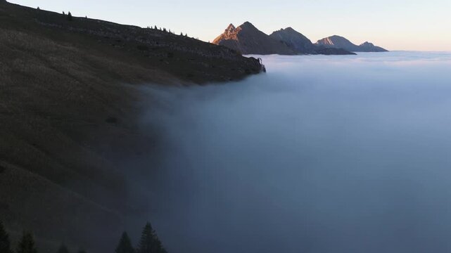 Aerial view of the majestic Dent de Jaman mountain peak piercing through a sea of ethereal clouds, creating a breathtaking, dreamy landscape, Montreux, Vaud, Switzerland.