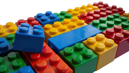 Colorful plastic building blocks are arranged in rows with red, yellow, green, and blue hues, creating a vibrant pattern