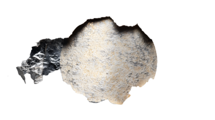 A silver scratch off area from a lottery ticket ripped and isolated on a white background with a rough torn edge and black burn marks with gaming