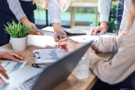 Executive business team people group working with documents at table, analyzing corporate strategy, reviewing plan, managing financial project overview at office meeting, digital tablet, laptop. - Powered by Adobe