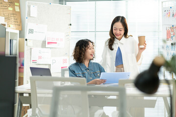 Businesswomen or creative designer are discussing and planning,Group of two businesspeople working with new startup project in office.concept of Starting a start up company,business planning,strategy