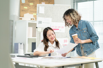 Businesswomen or creative designer are discussing and planning,Group of two businesspeople working with new startup project in office.concept of Starting a start up company,business planning,strategy