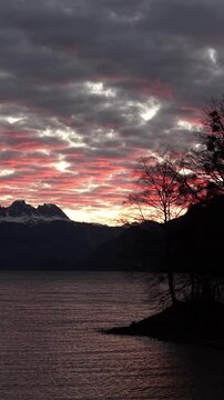 Vertical view of sunset clouds above Walensee lake and alpine mountains