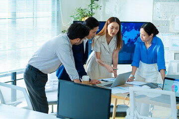 Teamwork meeting,tablet and asian business people in office workplace.Collaboration,technology and workers,men or employees with planning sales on laptop,financial strategy or research in company