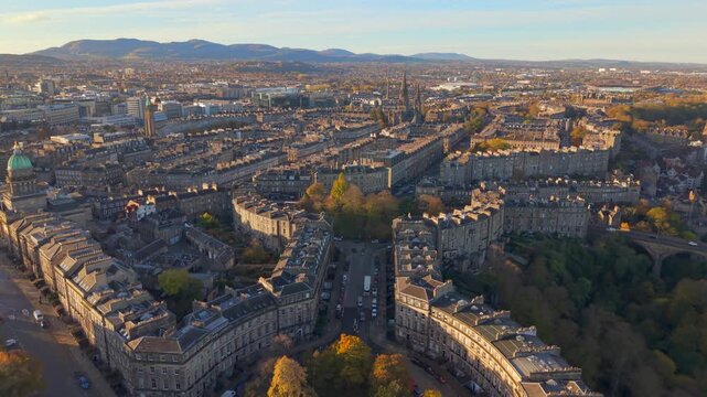 Aerial view of Moray Place showcasing its grand architecture amidst the autumnal foliage of the surrounding trees, Edinburgh, Scotland, United Kingdom.