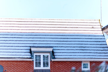 Roof covered with snow. Sunny and cold day.High quality photo
