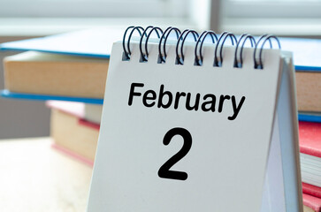 February 2 desk calendar on a clean workspace background