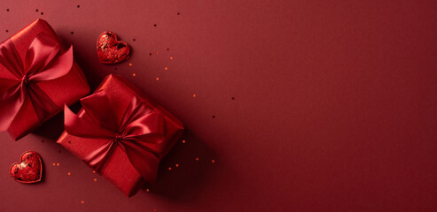 Vibrant banner red backdrop showcases wrapped gifts and heart accents, capturing romantic gift giving, affection, and Valentine&rsquo;s Day celebration perfect for greetings and love