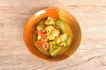 spicy boiled slice pork with eggplant in curry soup on bowl