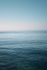 Fototapeta premium Aesthetic Summer Seascape with Sandy Beach and Gentle Ocean Waves under Warm Sunlight 