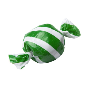 Close-up of green and white striped candy in wrapper against black backdrop