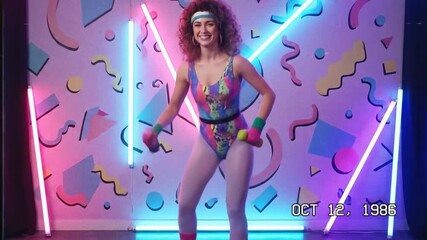 Retro Aerobics Instructor Exercising with Dumbbells in Neon 1980s Studio