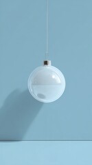 A minimalist winter flat lay featuring a pinecone, soft fabric and delicate white florals