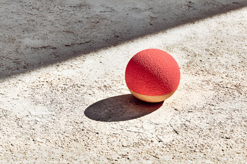 Red Ball on Sandy Ground Outdoor Scene.