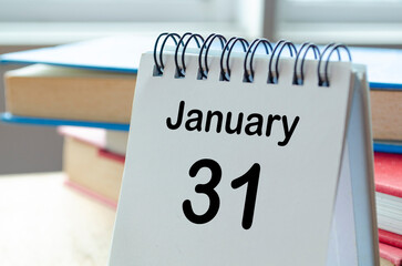 Desk calendar showing January 31 on blur office background