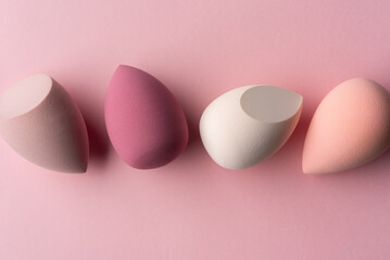 Pastel Makeup Sponges on Pink Background Minimal Beauty Concept