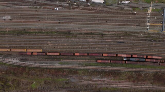 Aerial view of a trainyard with numerous tracks and wagons, showcasing a complex network of railway infrastructure, Nottingham, England, United Kingdom.