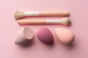 Minimal Makeup Tools with Soft Sponges and Brush on Pink Background