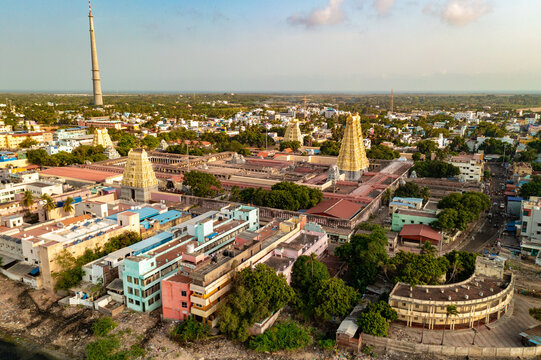 Aerial view of ancient temples and colorful buildings nestled amidst lush greenery, bathed in the soft glow of the sun, Dhanushkodi, Tamil Nadu, India.