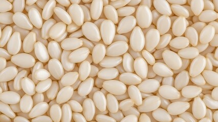 Detailed macro of numerous sesame seeds spread out on a flat surface
